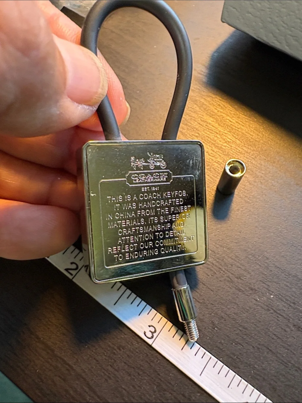 Coach Silver Creed Keychain with Black Pen.